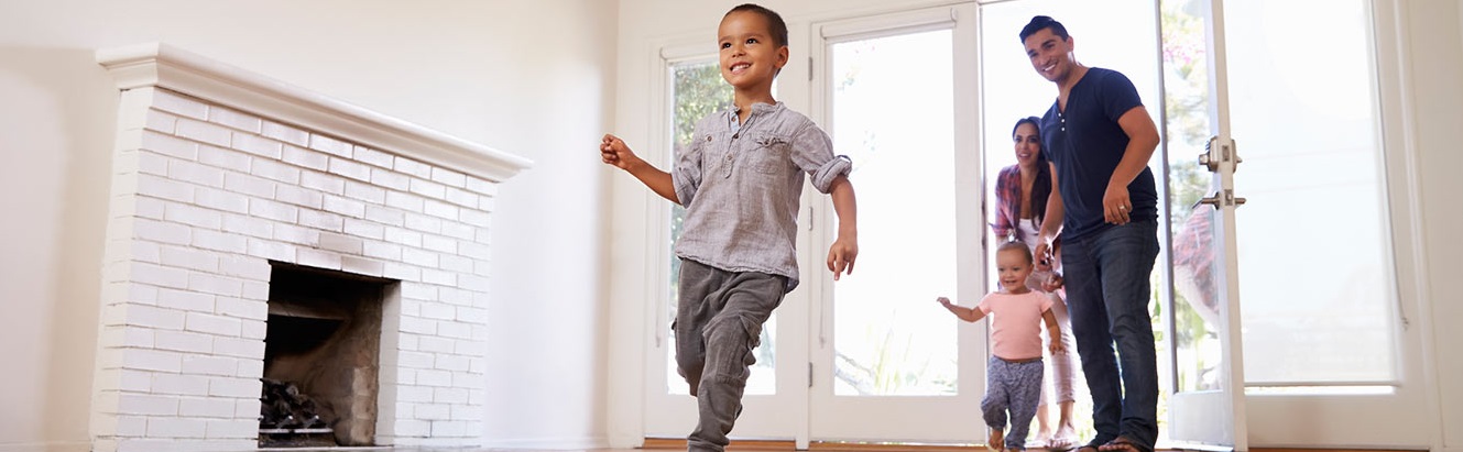 Excited young family enters new home.